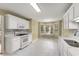 Bright kitchen featuring white cabinets, a bay window, and modern appliances at 5077 Fieldview Dr, Douglasville, GA 30135