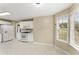 Bright kitchen area featuring white appliances, tile floors, and a bay window at 5077 Fieldview Dr, Douglasville, GA 30135