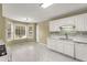 Modern kitchen featuring white cabinets, updated fixtures, and a spacious breakfast area at 5077 Fieldview Dr, Douglasville, GA 30135