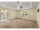 Large main bedroom featuring a tray ceiling, ceiling fan, and ensuite bath at 5077 Fieldview Dr, Douglasville, GA 30135