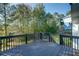 Enjoy this lovely back deck with relaxing wooded views and room for outdoor seating at 77 Hunters Grn, Dallas, GA 30157