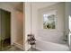 Bright bathroom with a soaking tub, tiled shower, and a window with natural light at 77 Hunters Grn, Dallas, GA 30157