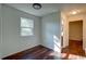 A cozy bedroom with hardwood floors and a large window letting in plenty of light at 77 Hunters Grn, Dallas, GA 30157