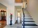 Welcoming foyer featuring a striking staircase with dark wood accents and neutral walls at 77 Hunters Grn, Dallas, GA 30157