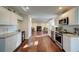 Open-concept kitchen with white cabinets, granite counters, stainless steel appliances, and hardwood floors at 77 Hunters Grn, Dallas, GA 30157