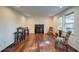 Bright living room featuring wood floors, a fireplace, and natural light from windows at 77 Hunters Grn, Dallas, GA 30157