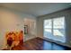 Bright living room with rich wood floors, neutral walls, large window, and view to the home's entrance at 77 Hunters Grn, Dallas, GA 30157