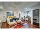 Relaxing main bedroom featuring a trey ceiling, hardwood floors, and a cozy seating area at 77 Hunters Grn, Dallas, GA 30157