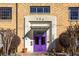 A charming brick building entrance featuring a purple door, decorative plants, and an awning at 794 Ralph Mcgill Ne Blvd # 8, Atlanta, GA 30312