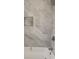 Modern bath with marble-look tile and shower fixture at 2215 Gordon Se Cir, Smyrna, GA 30080