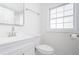 Bright bathroom with natural light and features a mirror, window, and white vanity at 2215 Gordon Se Cir, Smyrna, GA 30080