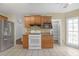 Kitchen with stainless steel appliances, tile flooring, and wood cabinets at 4142 Huntcliff Dr, Woodstock, GA 30189