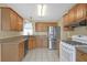 Functional kitchen with wood cabinets, stainless steel appliances, and a tiled floor at 4142 Huntcliff Dr, Woodstock, GA 30189