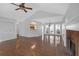 Open-concept living room with hardwood floors, a fireplace, and a view of the kitchen at 4142 Huntcliff Dr, Woodstock, GA 30189