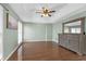 Spacious main bedroom with hardwood floors, a dresser, and two bright windows at 4142 Huntcliff Dr, Woodstock, GA 30189