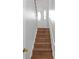 Staircase leading to the front door, featuring wooden steps and a white handrail at 4142 Huntcliff Dr, Woodstock, GA 30189