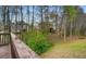 View from the deck overlooking the backyard with mature trees and lawn at 1536 Granby Ln, Locust Grove, GA 30248