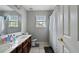 Bathroom with a double sink vanity, toilet, shower with curtain, and a large mirror at 1536 Granby Ln, Locust Grove, GA 30248