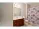 Standard bathroom with a vanity, toilet, and shower with patterned curtain at 1536 Granby Ln, Locust Grove, GA 30248