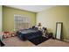 Bedroom showcasing carpet floors, olive colored walls, and a window with a view at 1536 Granby Ln, Locust Grove, GA 30248
