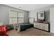 Bedroom offering neutral walls, window with blinds, carpeted floor and a wooden dresser at 1536 Granby Ln, Locust Grove, GA 30248