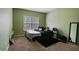 Bedroom featuring carpet floors, neutral walls, a window and a bed with nightstand at 1536 Granby Ln, Locust Grove, GA 30248