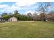 Sprawling backyard featuring a storage shed and mature trees at 3811 Lavilla Dr, Powder Springs, GA 30127