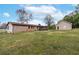 Spacious backyard featuring a large lawn and a detached garage and screened-in porch at 3811 Lavilla Dr, Powder Springs, GA 30127