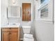 Small bathroom featuring a modern sink, toilet, and dark wood cabinetry at 3811 Lavilla Dr, Powder Springs, GA 30127
