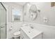 Bathroom with white vanity, sink, toilet, walk in shower with glass door, and a window at 3811 Lavilla Dr, Powder Springs, GA 30127