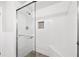 Bathroom with white tile and glass shower door and a built in seat at 3811 Lavilla Dr, Powder Springs, GA 30127