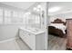Bright bathroom featuring a double vanity, neutral walls, and access to the bedroom at 3811 Lavilla Dr, Powder Springs, GA 30127