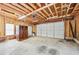 Unfinished garage interior with a white door, a window and a white garage door at 3811 Lavilla Dr, Powder Springs, GA 30127
