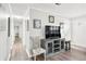 Living room features gray wood floors, a console table, and paneled walls at 3811 Lavilla Dr, Powder Springs, GA 30127