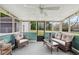 Inviting sunroom features comfortable seating, a ceiling fan, and natural light at 3811 Lavilla Dr, Powder Springs, GA 30127
