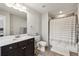 A well-lit bathroom features a dark wood vanity, a toilet and a tiled shower at 4125 Barry Pl, Chamblee, GA 30341