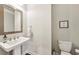 Clean bathroom featuring a pedestal sink, toilet, and a simple, elegant design at 4125 Barry Pl, Chamblee, GA 30341