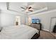 The bedroom with a tray ceiling has carpet floors, a dresser, and a ceiling fan at 4125 Barry Pl, Chamblee, GA 30341