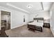 A bright bedroom with carpet floors has a bed with modern wood furniture at 4125 Barry Pl, Chamblee, GA 30341