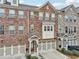 Three-story townhome with a brick and stone facade, and attached garages at 4125 Barry Pl, Chamblee, GA 30341