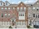 Charming townhomes featuring diverse brick and stone facades, complemented by symmetrical garage doors at 4125 Barry Pl, Chamblee, GA 30341