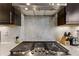 Close-up on gas stovetop and backsplash, highlighting the modern kitchen design at 4125 Barry Pl, Chamblee, GA 30341
