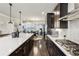 Spacious kitchen with stainless steel appliances, dark cabinets, quartz counters and modern lighting at 4125 Barry Pl, Chamblee, GA 30341