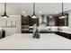 Bright kitchen showcasing a large island with quartz countertops, dark cabinets and stainless steel appliances at 4125 Barry Pl, Chamblee, GA 30341