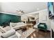 Bright living room featuring a sleek fireplace, modern furnishings, hardwood flooring, and dining access at 4125 Barry Pl, Chamblee, GA 30341