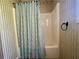 Bathroom with modern bathtub, elegant shower curtain, and stylish wall decor at 413 Remington Ct, Villa Rica, GA 30180