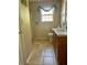 This bathroom features beige tiled floors, a single sink vanity, and a shower behind a patterned shower curtain at 413 Remington Ct, Villa Rica, GA 30180