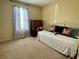 Bedroom with a large window, a day bed with butterfly pillows, and wooden dresser at 413 Remington Ct, Villa Rica, GA 30180