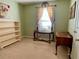 View of the bedroom featuring neutral-toned walls, large windows, and vintage furniture at 413 Remington Ct, Villa Rica, GA 30180