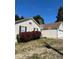 This single Gathering home boasts a two car garage and green front lawn with lush shrubbery around the front window at 413 Remington Ct, Villa Rica, GA 30180